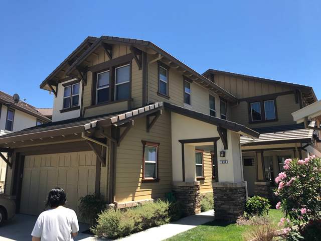 Painter at work on a two-story craftsman