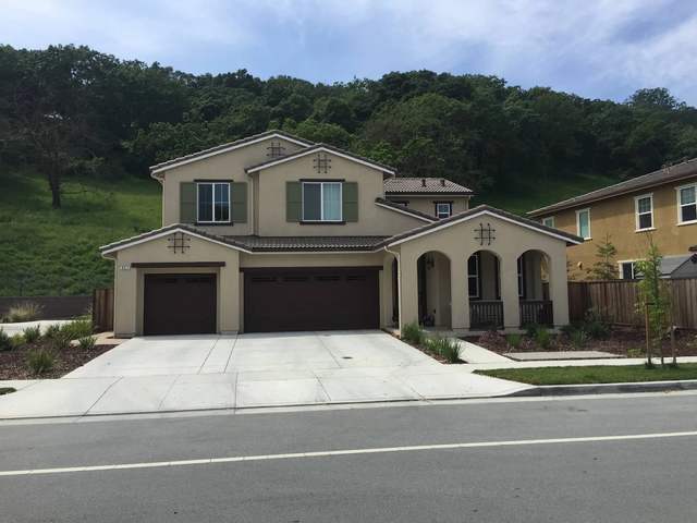 Cream stucco two-story home with a three-car garage after painting
