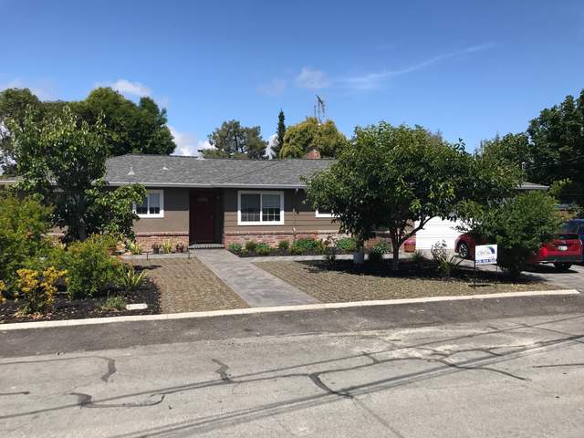 Ranch home exterior repainted, mature trees in front