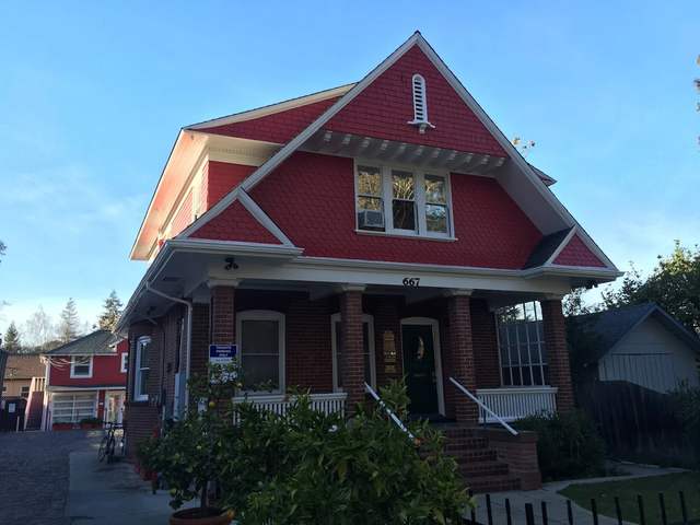 Red craftsman home with cream trim