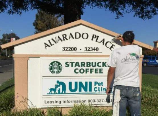Painting a shopping center monument sign