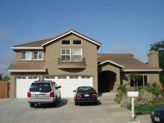 Two-story tan home with white trim